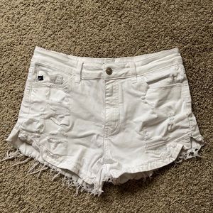 white denim jeans with tears. the tears higher up, are covered with material!